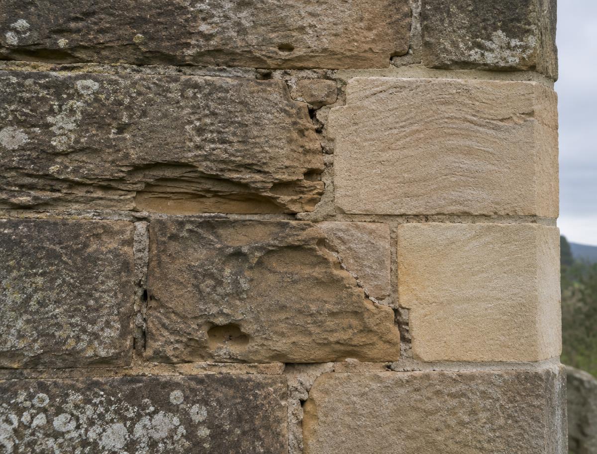 New stone set beside weathered masonry